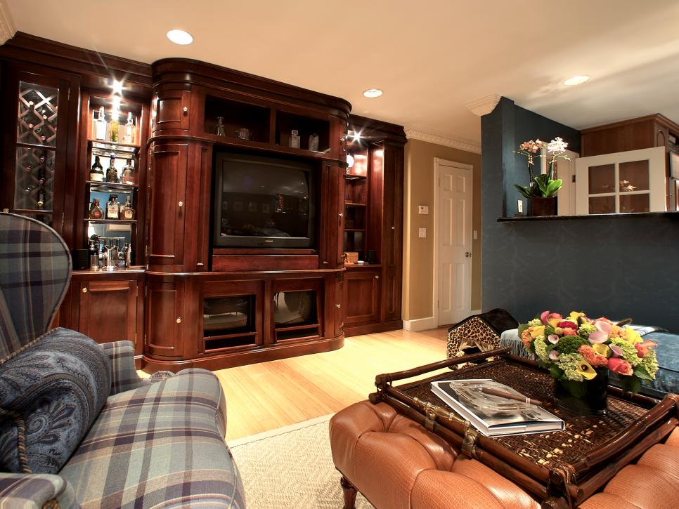 Family Room With Dark Wood Entertainment Unit and Tufted Ottoman