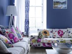 Blue Living Space With Floral Sofa and Pillows