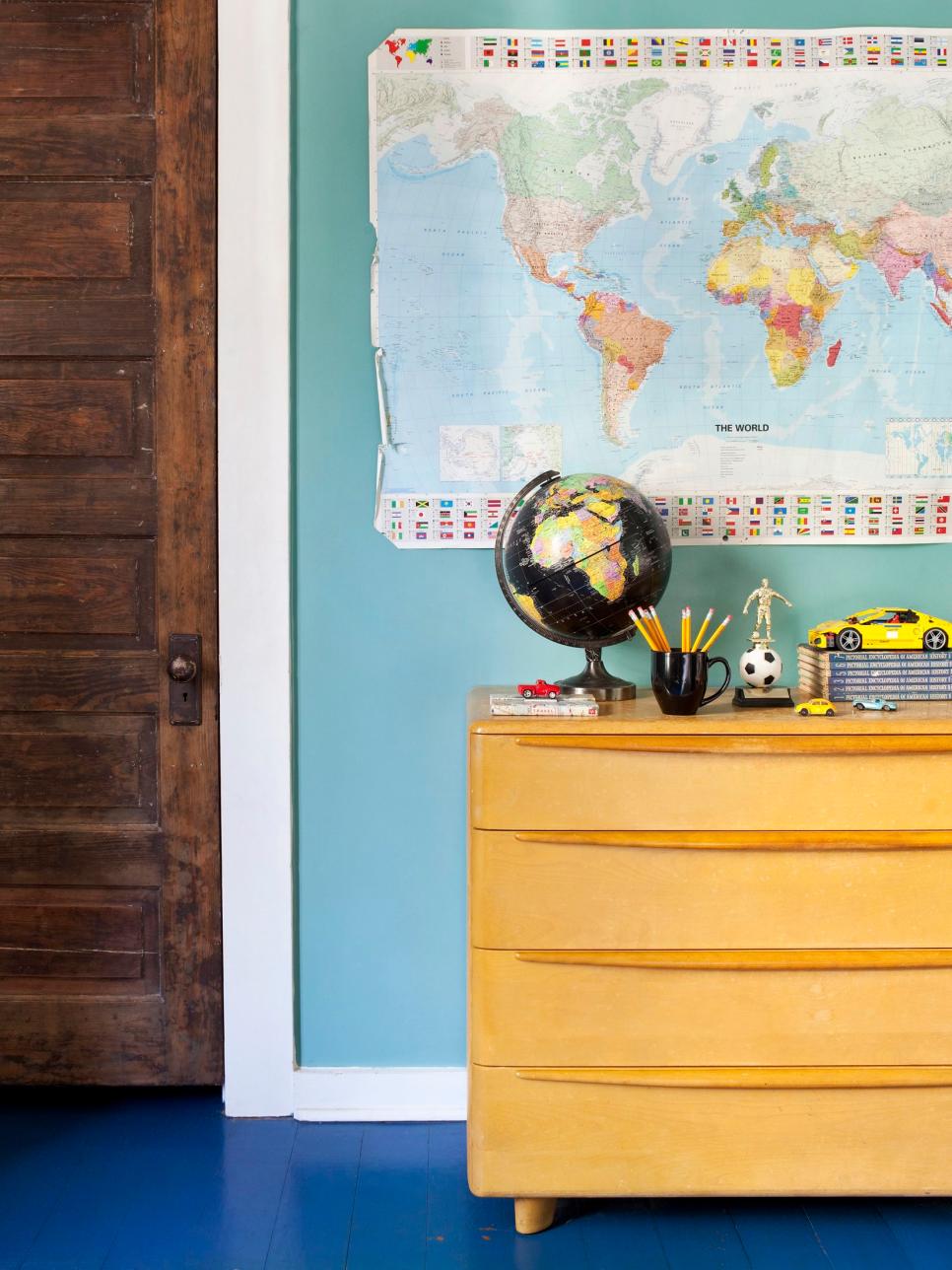Eclectic Kids' Bedroom Vintage Yellow Dresser and Map Decor