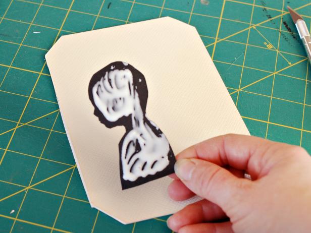 Using a ruler, determine the center of mat and mark center. Apply craft glue to back side of silhouette. Tip: Keep glue away from silhouette's edges to prevent excess from squeezing out.