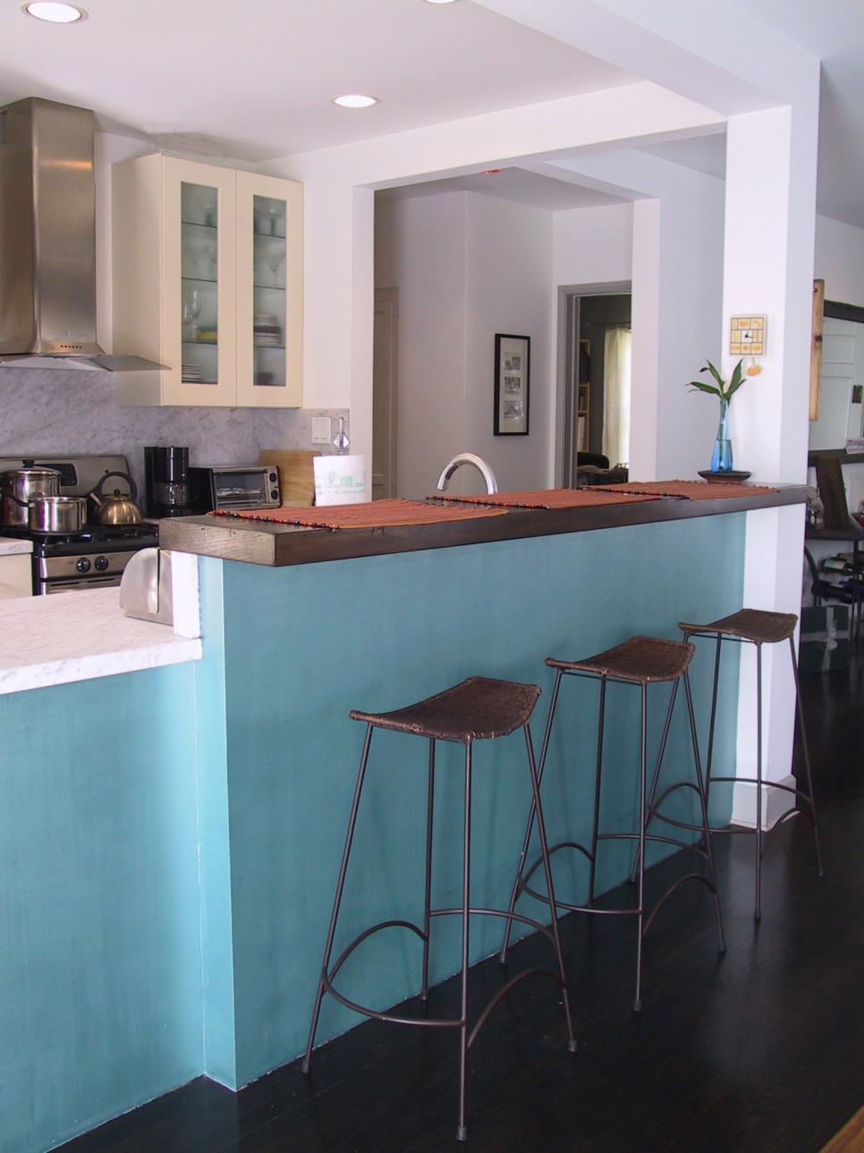 Small Open-Layout Kitchen With Sky-Blue Bar and Barstools