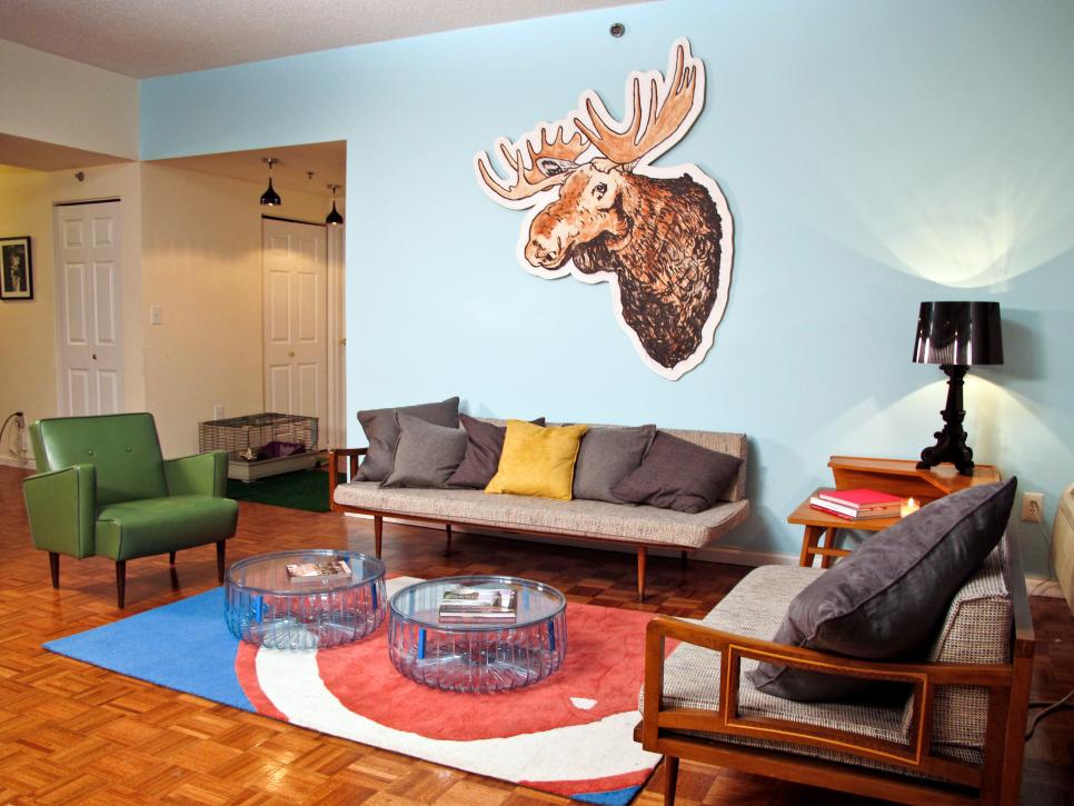 Blue Living Room With Moose Head Art, Green Chair and Neutral Sofas