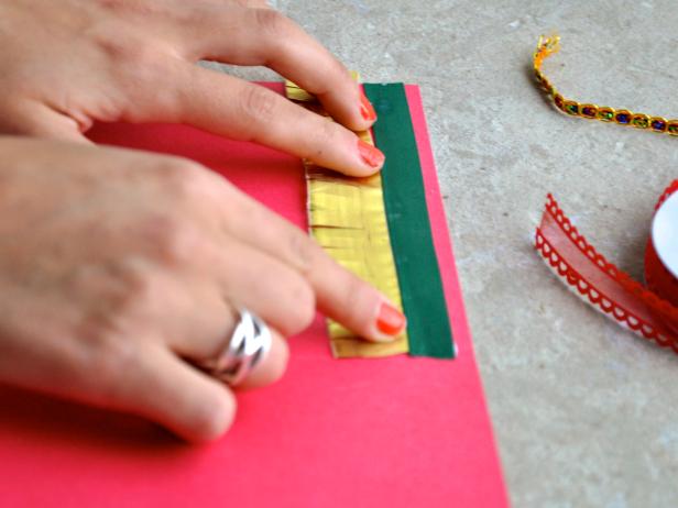 Starting from the top of card, attach ribbon to card front with hot glue. Continue layering ribbon, alternating textures and colors, until entire front of card is covered. Tip: To ensure proper spacing and complementary pattern placement, lay ribbon segments down first, then glue.