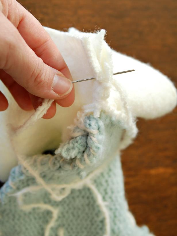 To create a cuff, cut a 3" x 18" panel from the bottom of the sweater, bottom is better since one side already has a seam. Stitch together so seam is showing on outside of the stocking. This will be hidden once the cuff is folded over. Continue stitching around the top of stocking until ends meet on "heel" side of stocking.