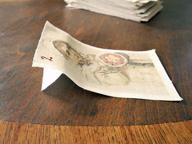 Fold down the freezer paper to act as a stand as the glue dries. Tip: Some no-fray glues can cause ink to run. To prevent this, pour glue onto a paper plate and dip very top edge of each pocket into the glue for a more controlled application.