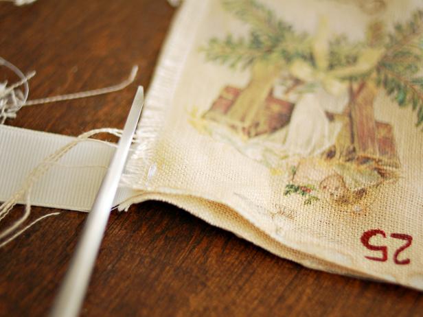 Trim excess threads. Apply no-fray glue to raw edges of ribbon and allow to dry. Fill the pockets with candy and small presents to build the anticipation of Christmas day. Tip: This advent calendar can be used in a variety of ways.