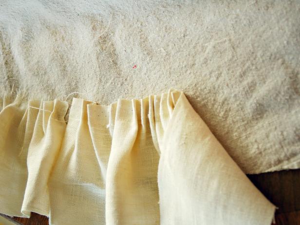 Work in small sections, no more than about 12 inches at a time. Continue this process around the entire skirt edge. Start the next row approximately 1 1/2 inches above the previous row. Continue adding rows until entire canvas base is covered.
