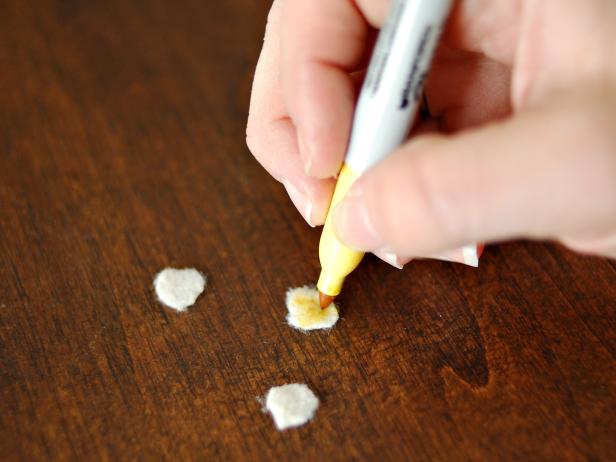 Cut small circles out of cream felt. Color each with a permanent yellow marker.
