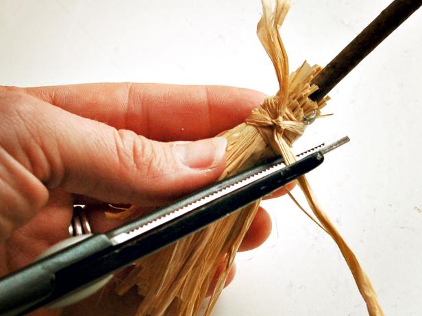 Cut excess raffia used to secure bunch to twig.