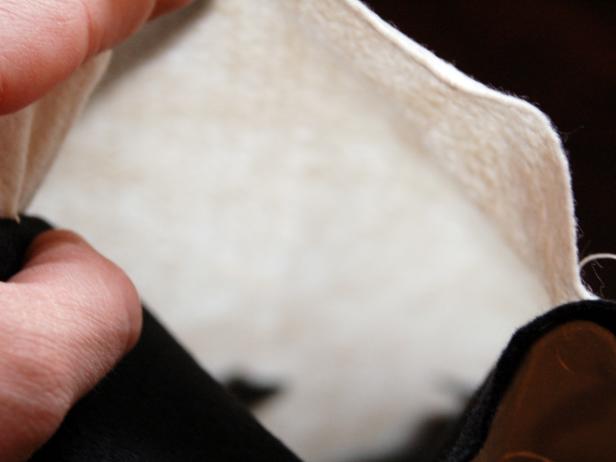 A swatch of cream fabric is used for a Halloween applique pillow with bat designs.