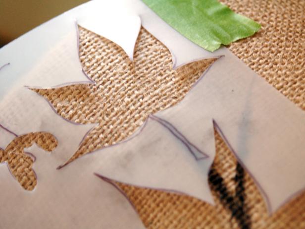 Secure leaf stencil to lampshade with painter's tape.