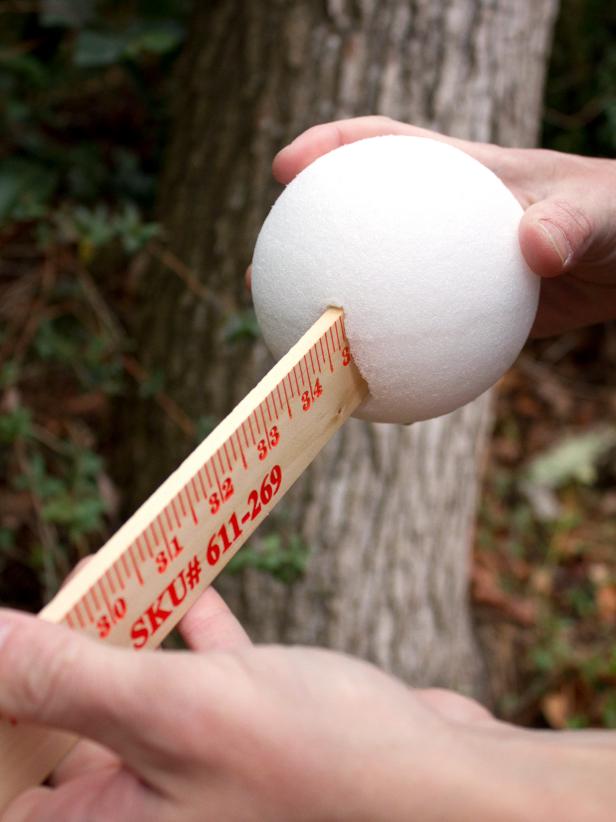 DIY Halloween Ghost's Hands Made From Foam Balls Attached To Yardsticks