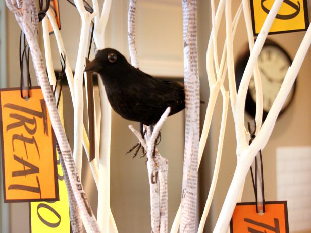 Hang cards on branches and finish the centerpiece by attaching a black crow.