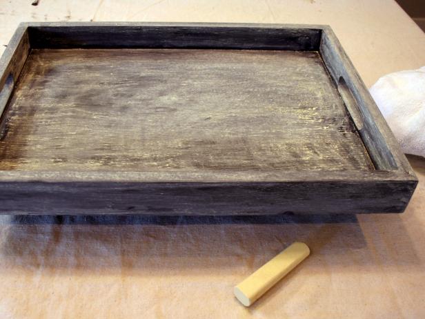 Prepare tray for writing by covering surfaces using a large chalk stick on its side. This allows all future markings to be fully erasable.