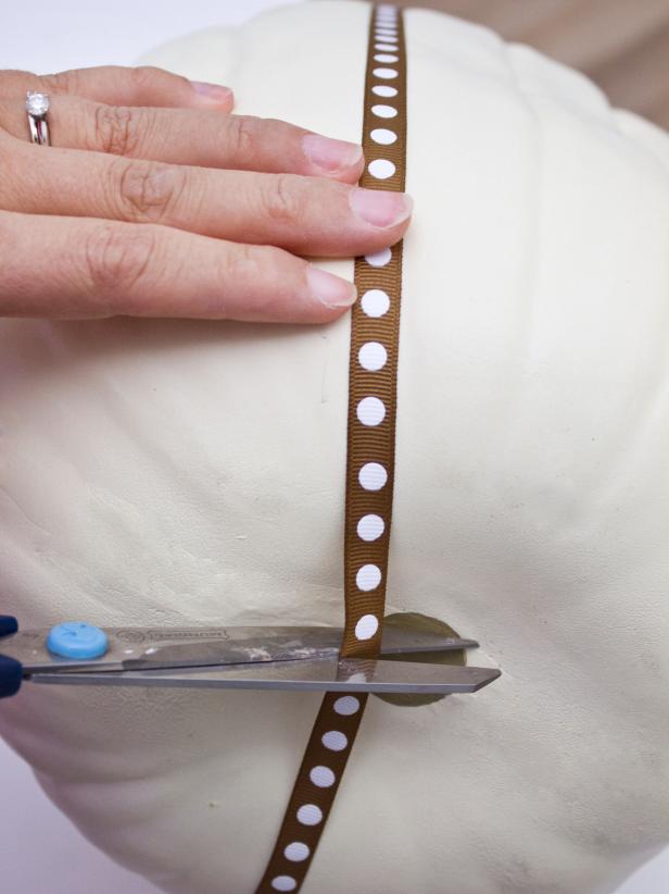 Use scissors to cut the ribbon off once you've determined the correct length for your pumpkin.