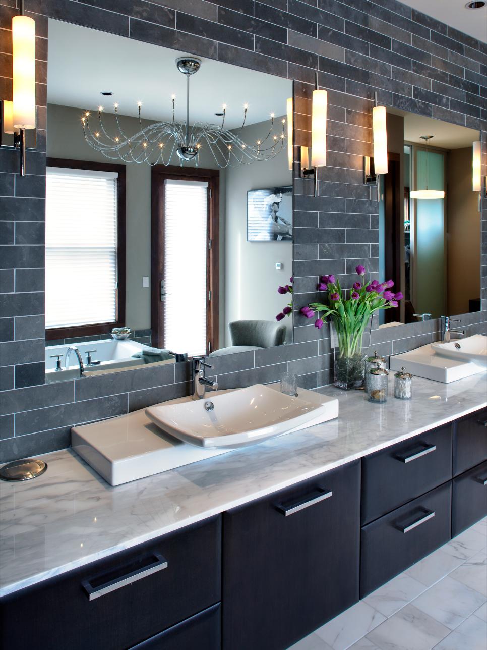 Gray Bathroom With Sconces and Black Vanity With Marble Countertop