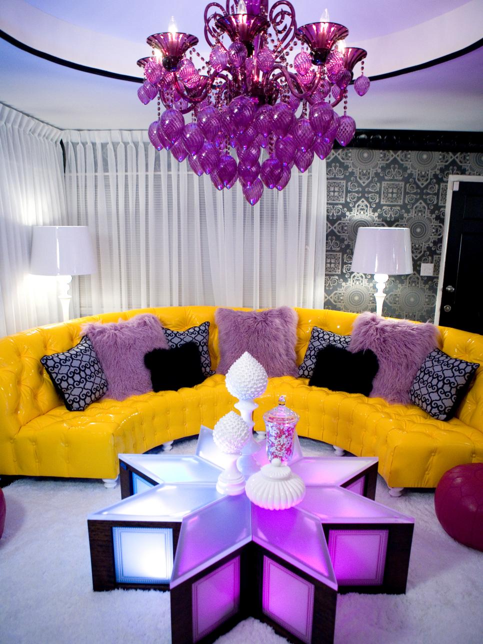 Eclectic Living Room With Curved Yellow Sofa and Purple Chandelier