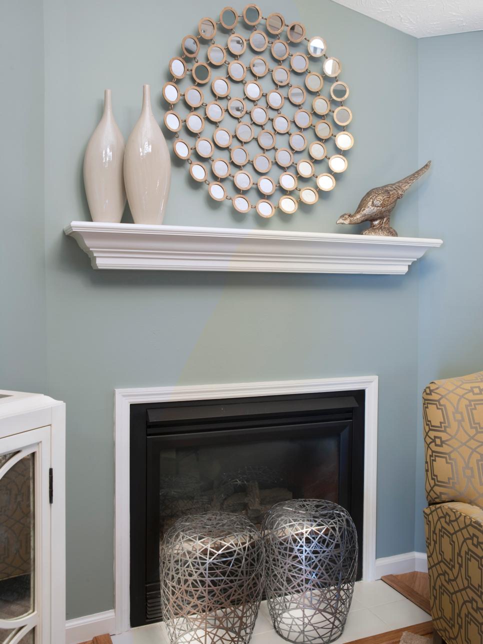 Curved Metallic Accents Balance Square Fireplace Blue-Gray Living Room With Small Fireplace and Metallic Accessories
