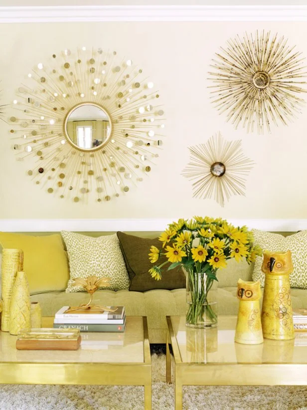 Neutral and contemporary, this living room has a low-slung sofa with solid and cheetah-print throw pillows. Sunburst mirrors reflect the space and bounce light around the room.