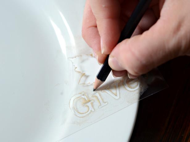Wash and dry plates. Position stencil in desired location on plate and hold firmly or tape into place. Lightly trace design with a pencil.
