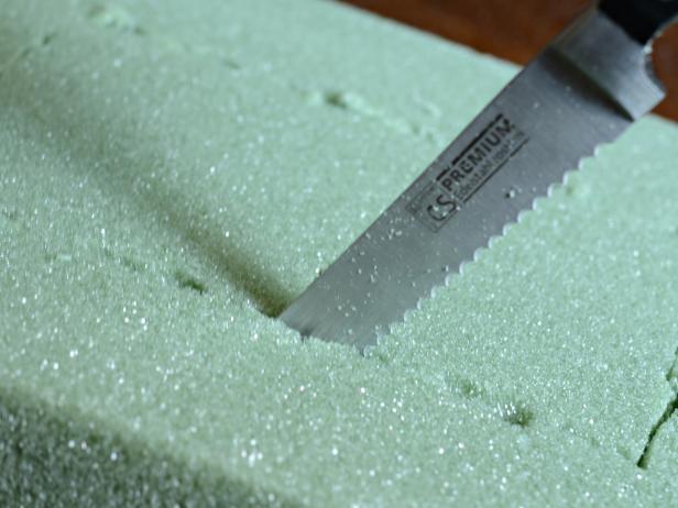 Use large serrated knife to cut floral foam on marked lines. Tip: This is a messy process that is best done outside.