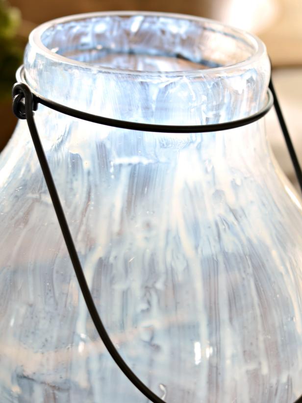 Clean and dry glass. Using a one-inch artists' brush, apply a thin layer of leaf adhesive to inside of hurricane (Images 1 and 2). Allow to dry until adhesive is clear and tacky (Image 3). Tip: To eliminate possible drips or pooling, gently brush over adhesive after about 10 minutes of drying time to create a smooth surface.