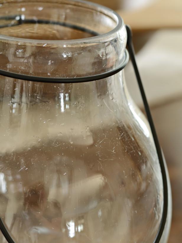 Clean and dry glass. Using a one-inch artists' brush, apply a thin layer of leaf adhesive to inside of hurricane (Images 1 and 2). Allow to dry until adhesive is clear and tacky (Image 3). Tip: To eliminate possible drips or pooling, gently brush over adhesive after about 10 minutes of drying time to create a smooth surface.