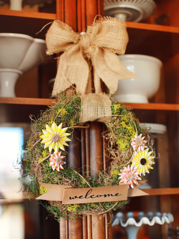 Warmly welcome Thanksgiving dinner guests with this sweet rustic wreath. Use hot glue to attach moss to a foam wreath form, completely covering all sides. Attach paper medallions to the wreath with hot glue and embellish centers of medallions with buttons. Print "welcome" greeting onto craft paper, and cut out accordingly.