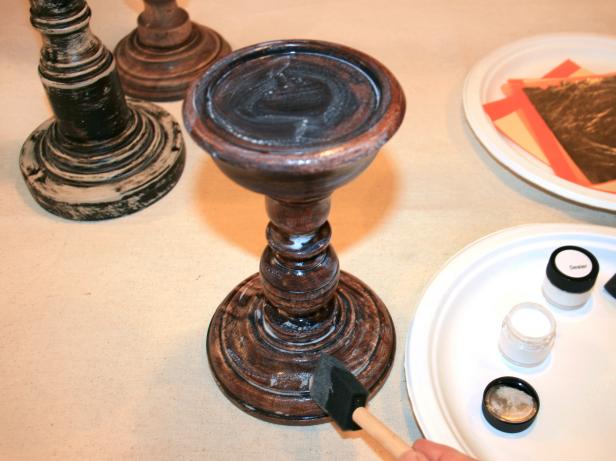 Apply gold-leaf adhesive to candlesticks.