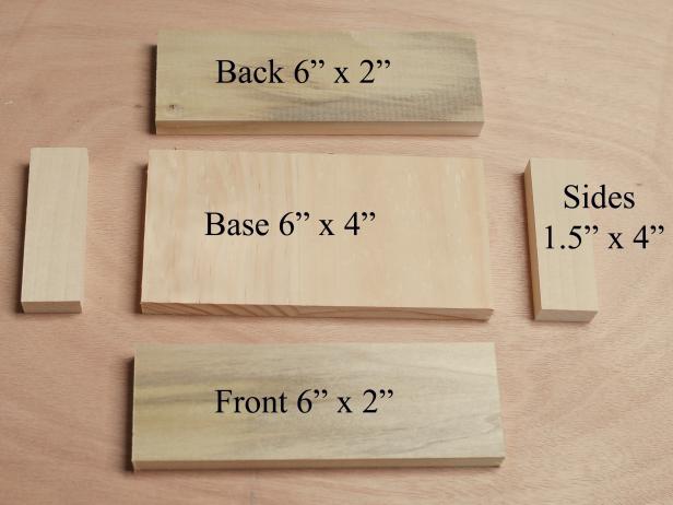 Cut poplar pieces to size on table saw. Cut a 1/2" wide x 1/4" deep dado on top side of top piece, 1/2 inch from front edge of box top. These poplar wood blocks are cut to size to make a chalkboard stocking hanger.