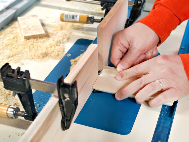 Glue on base top and clamp into place. Once fully dry, remove from clamps. The edge of this poplar wood lid is routed to make a chalkboard stocking hanger.