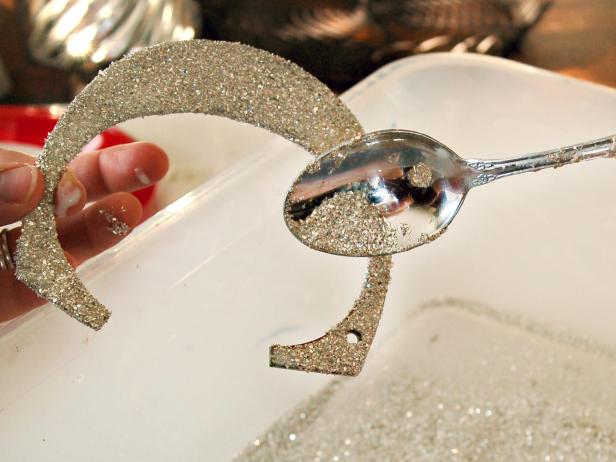 Pouring Glitter on a Christmas Banner Letter Pouring Glitter on a Christmas Banner Letter