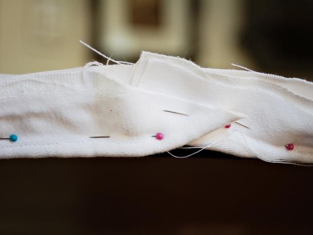 Fold ends under where piping edges meet. Sew using a zipper foot and remove pins.