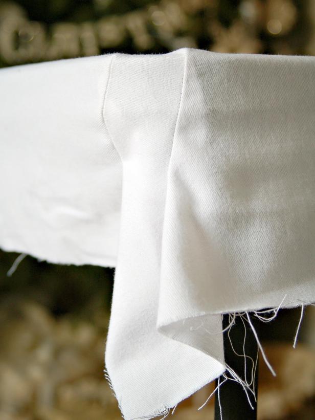 Sew each dart and remove pins. Turn slipcover over and put on table to ensure a tight fit.