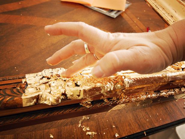 Pick up these flakes and use them to fill in small gaps in leaf. Continue this process until frame is fully covered in gold leaf. It will look rough and a little "shaggy."
