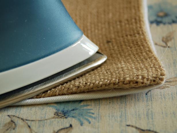 Fold ends of runner under and close using an iron. Make sure burlap and twill line up. Repeat on other end.