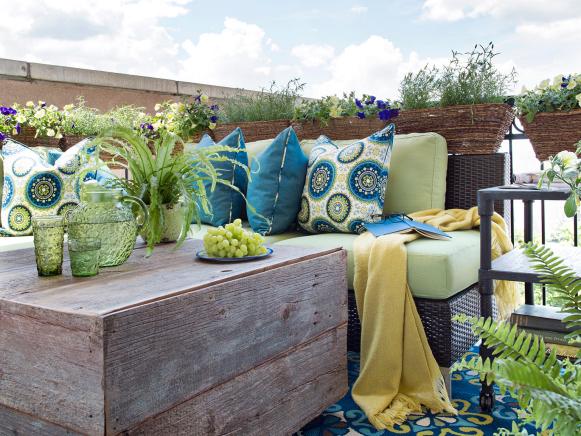 Outdoor Sitting Area With Wood Coffee Table and Blue Patterned Rug