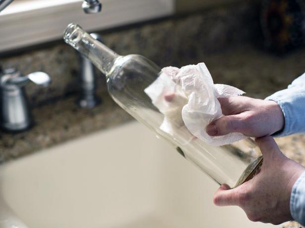 It's likely that once the stickers are removed, there will be remaining adhesive buildup or residue. Run hot water over the bottle's exterior, then use fingernails to remove sticker residue or buildup. If the residue doesn't easily come off, add liquid sticker remover to the exterior with a dry cloth or paper towel. After a few seconds, the residue may soften and instantly come off. Use dry cloth or paper towel to dry the exterior of each wine bottle.