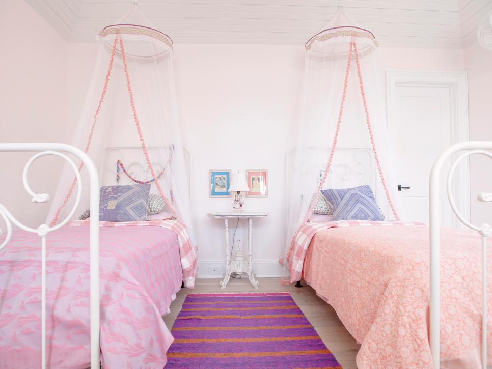 Pink Girls' Bedroom With Two Twin Beds, Canopies and Purple Rug