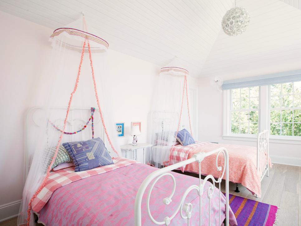 Light Pink Bedroom With White Iron Twin Beds and Sheer Canopies