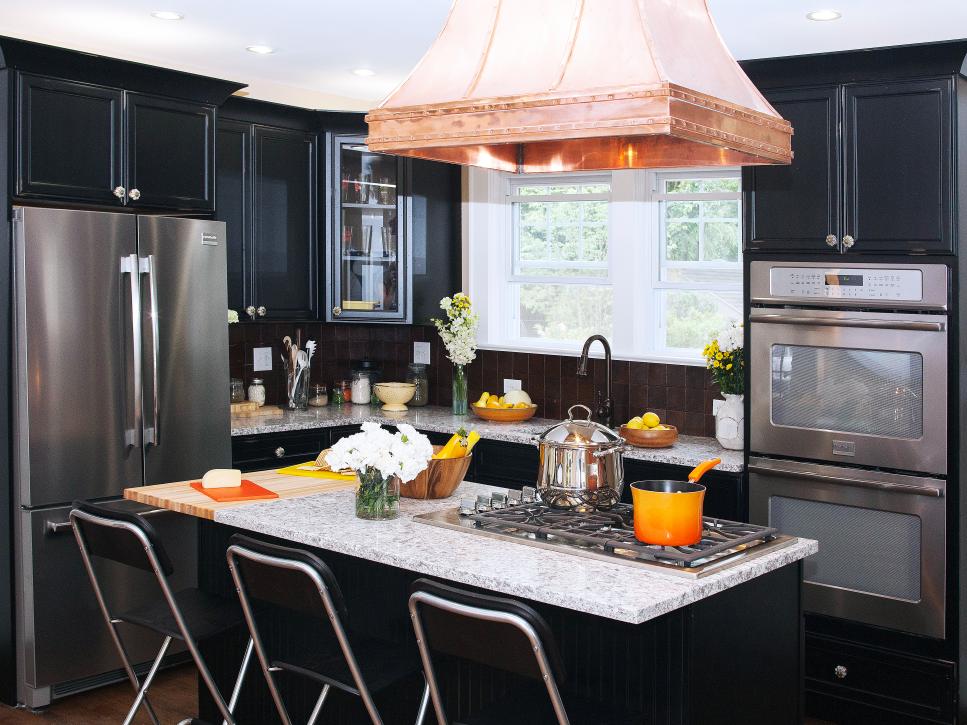 Neutral Colonial Kitchen With Black Cabinets and Copper Range Hood
