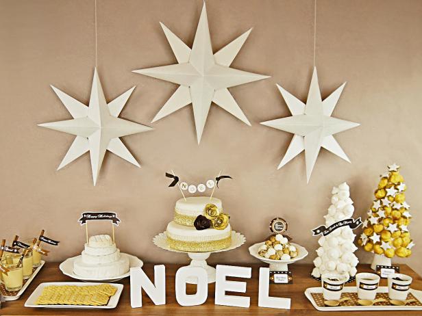 A buffet table displays several desserts for a Christmas party.