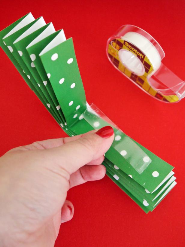 Fold each widthways and secure with tape. Attach all three pieces together and secure the middle with double-sided tape.