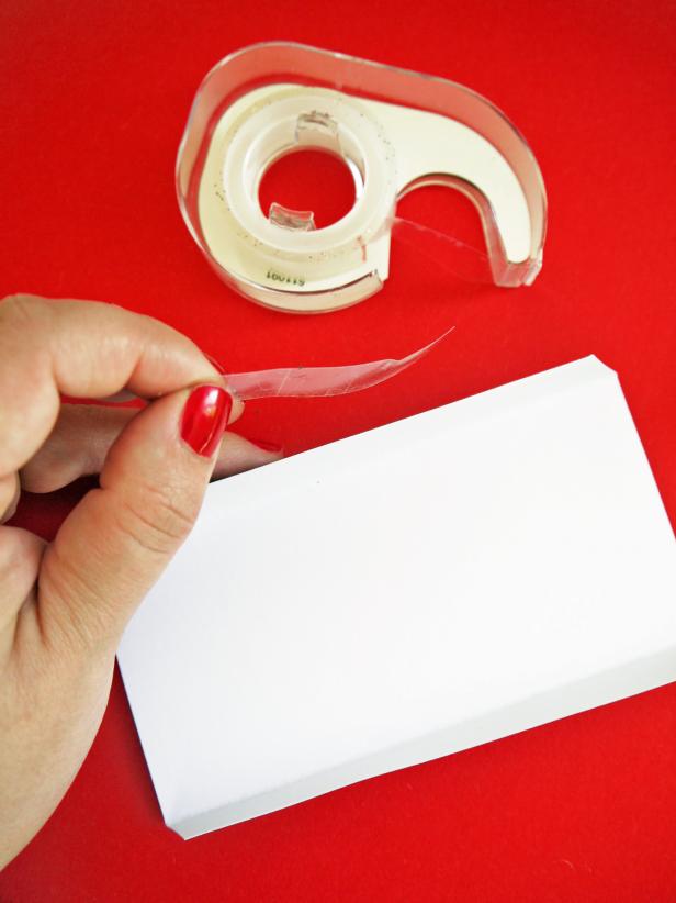 Secure bottom of sleigh to the part A with double-sided tape. Secure part A and B together with double-sided tape. Attach front and back of sleigh with double-sided tape.