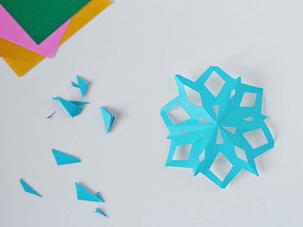 Unfold the snowflake, admire your handiwork and smooth the snowflake to flatten.