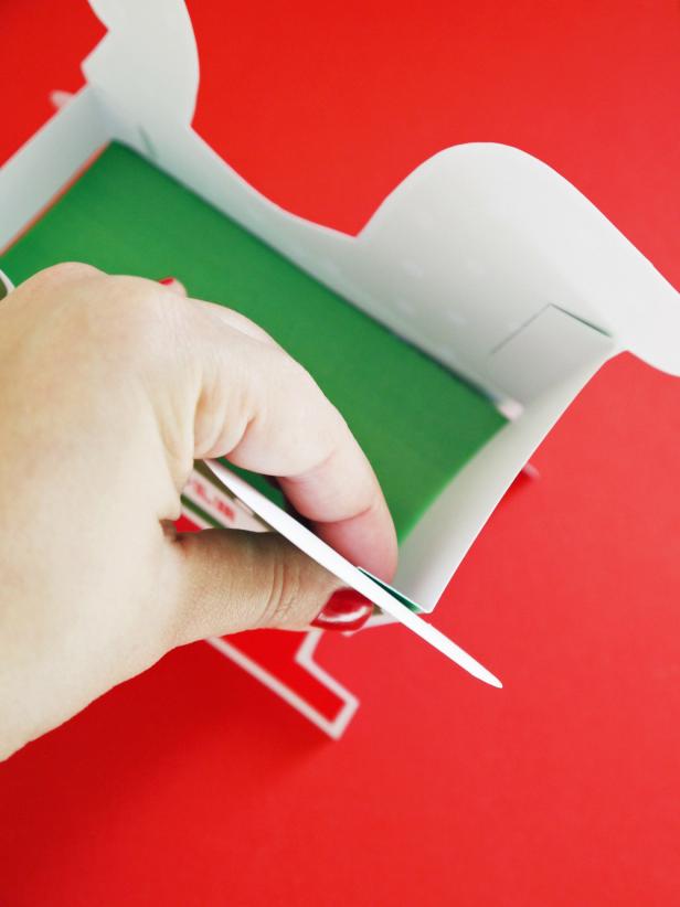 Secure part A and B together with double-sided tape. Attach front and back of sleigh with double-sided tape.