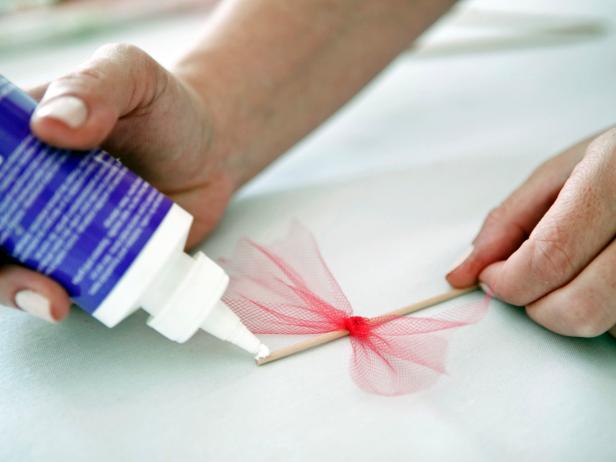Glue tulle into place at the very top of the cocktail stirrer.
