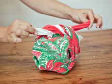 Bring retro holiday patterns to your party with dish towel favors made from vintage Christmas tablecloths.