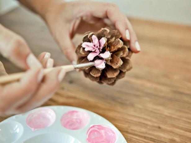 Starting at the top of the pinecone with the lightest shade, paint the top few rows of petals. Paint the middle of the pinecone with the medium shade, and the bottom of the pinecone with the darkest shade.