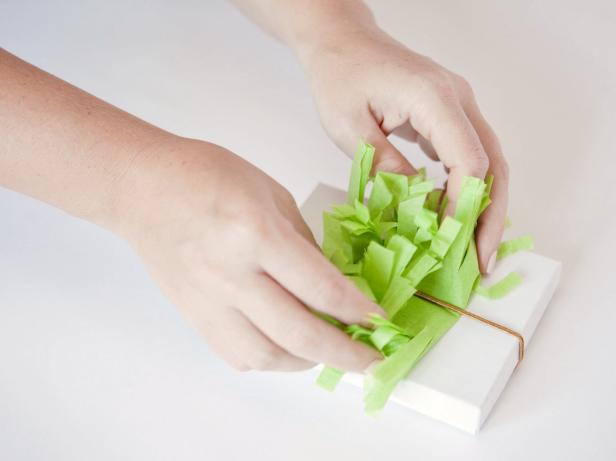 Turn the box over and fluff and crunch the fringed tissue paper to create a fun pouf.